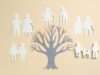 Family tree and cutouts on beige background, top view